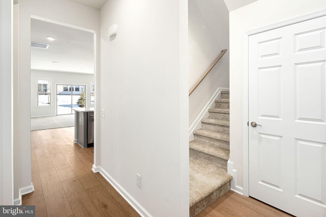 stairs featuring hardwood / wood-style flooring