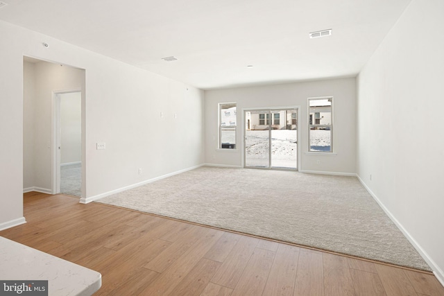 unfurnished room with light hardwood / wood-style flooring