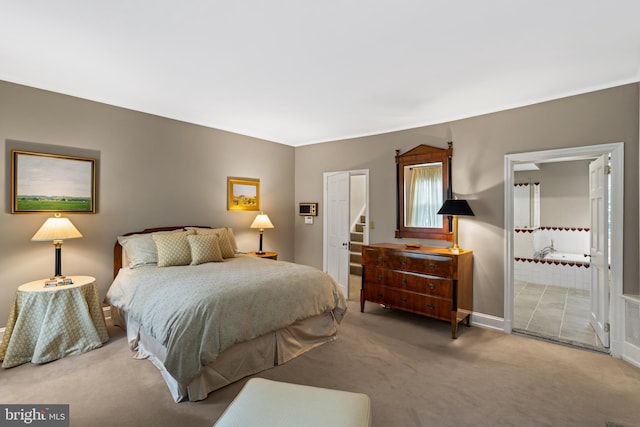 carpeted bedroom featuring ensuite bathroom