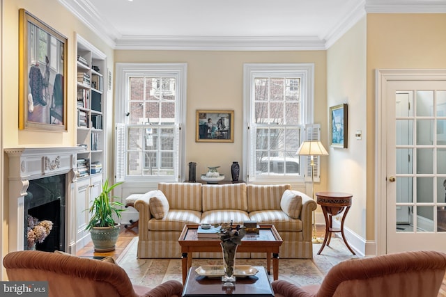 living room featuring ornamental molding, built in features, and a fireplace