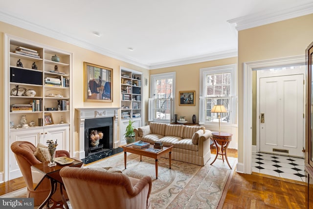 living room with crown molding, dark parquet floors, a premium fireplace, and built in features