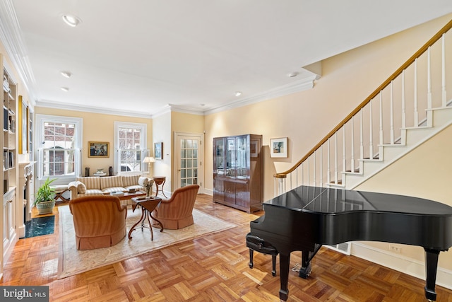 living area with crown molding and light parquet floors