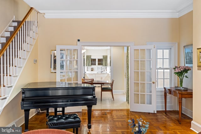 miscellaneous room with parquet floors, ornamental molding, and french doors