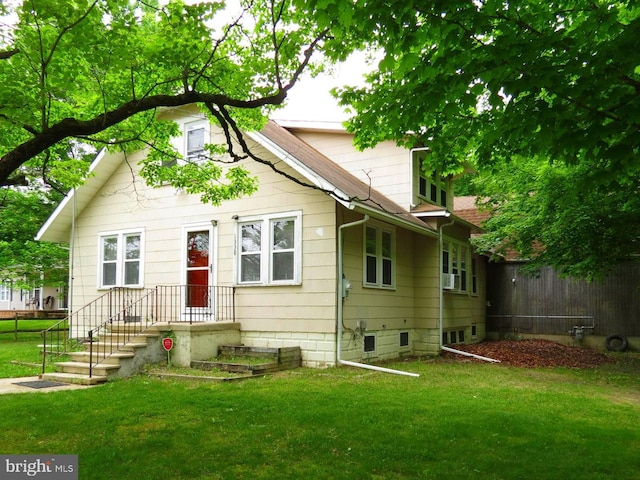 rear view of house featuring a yard