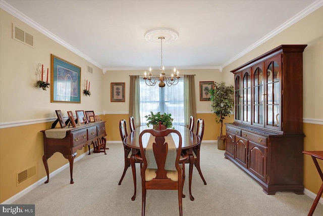 dining area featuring ornamental molding, light carpet, and a notable chandelier