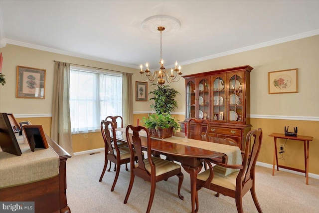 carpeted dining room featuring crown molding and a notable chandelier