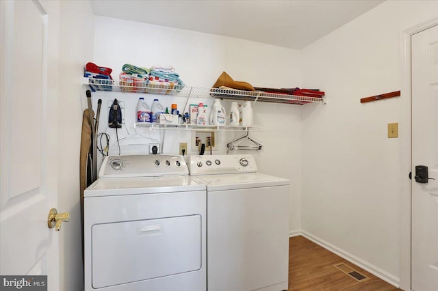 laundry area featuring hardwood / wood-style floors and independent washer and dryer