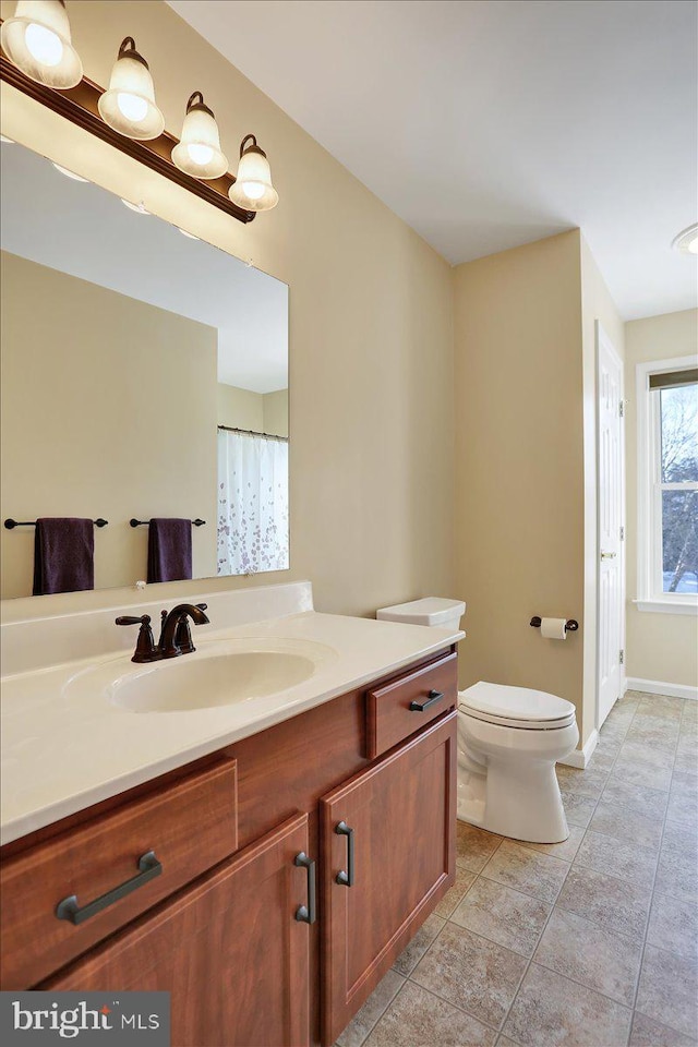 bathroom featuring vanity and toilet