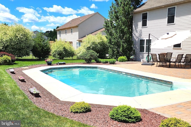 view of swimming pool with a patio and a yard