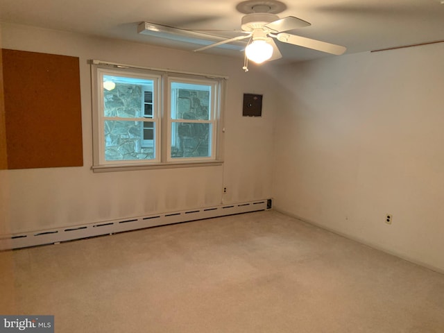 carpeted spare room with baseboard heating and ceiling fan