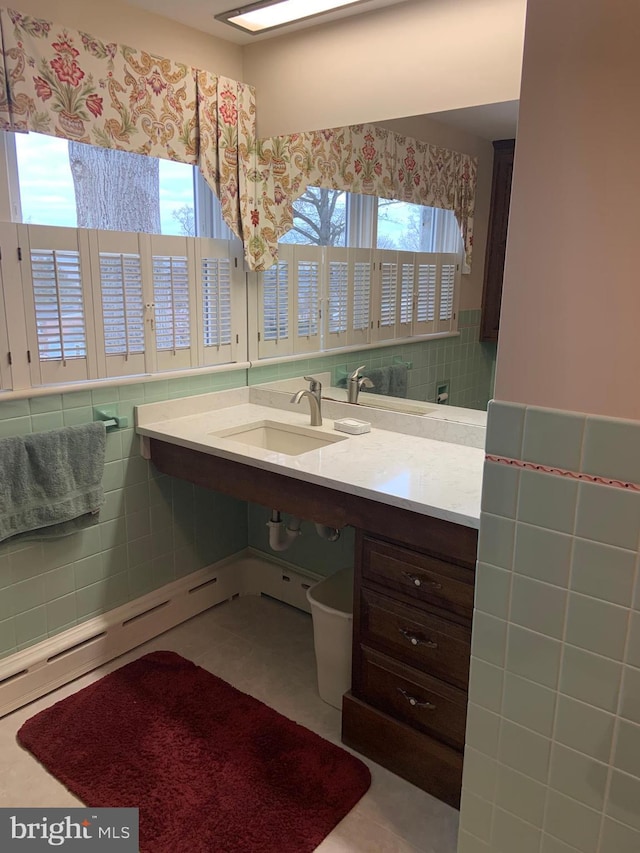 bathroom featuring tile patterned flooring, tile walls, and vanity