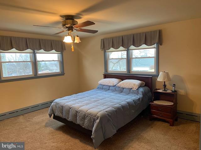 bedroom featuring ceiling fan, baseboard heating, and carpet floors