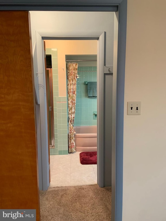 corridor featuring tile walls and tile patterned floors