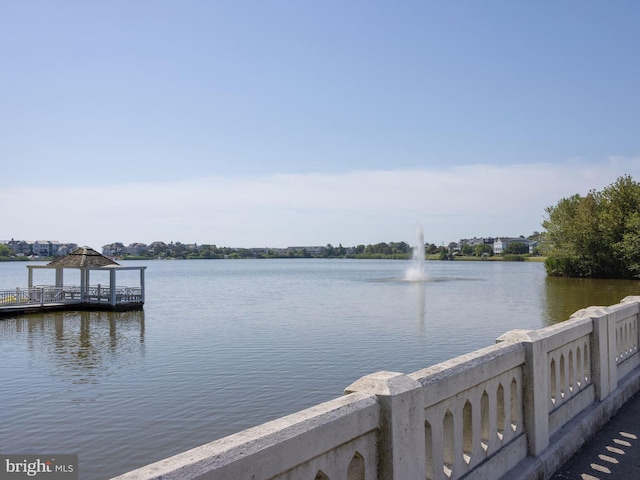 view of dock with a water view and a gazebo