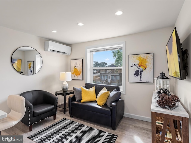 living room featuring a wall mounted AC and light hardwood / wood-style flooring