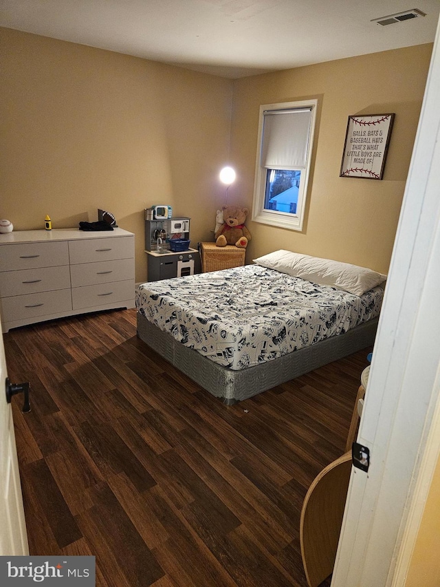 bedroom featuring dark hardwood / wood-style floors