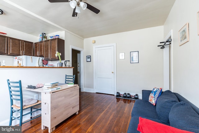 kitchen with ceiling fan, dark brown cabinets, dark hardwood / wood-style floors, kitchen peninsula, and white fridge