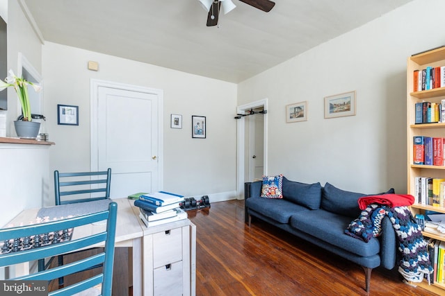 living room featuring ceiling fan and dark hardwood / wood-style flooring