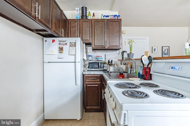 kitchen with sink, decorative backsplash, light tile patterned floors, dark brown cabinetry, and white appliances