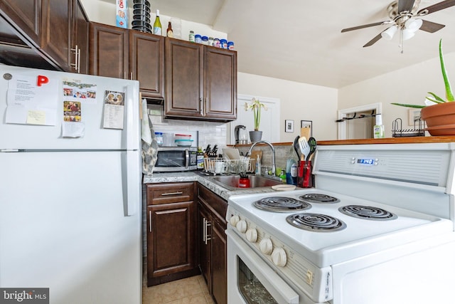 kitchen featuring sink, white appliances, tasteful backsplash, dark brown cabinetry, and light tile patterned flooring