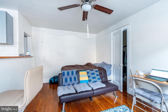 living room featuring dark hardwood / wood-style floors and ceiling fan