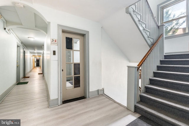 stairs featuring hardwood / wood-style floors