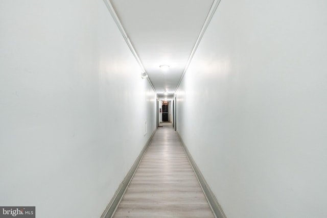 corridor with light hardwood / wood-style flooring