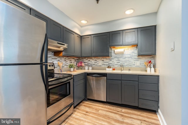 kitchen with sink, appliances with stainless steel finishes, gray cabinetry, and light hardwood / wood-style flooring