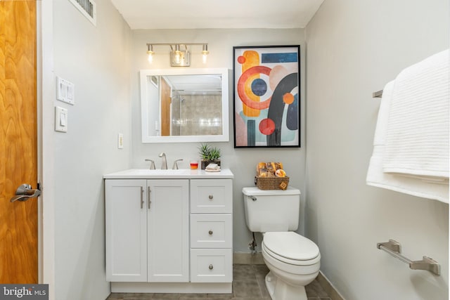 bathroom with vanity, toilet, and tile patterned flooring