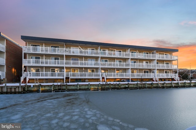 outdoor building at dusk featuring a water view