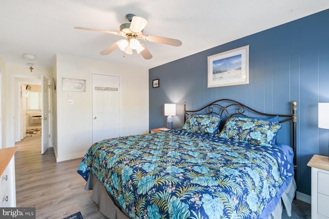 bedroom featuring light hardwood / wood-style floors and ceiling fan