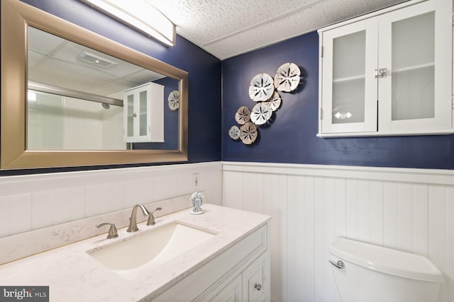 bathroom with vanity, a paneled ceiling, and toilet