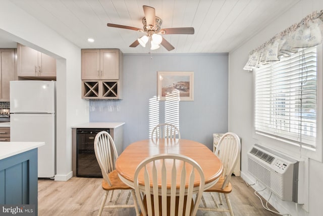 dining area with light hardwood / wood-style floors, beverage cooler, wooden ceiling, and bar area