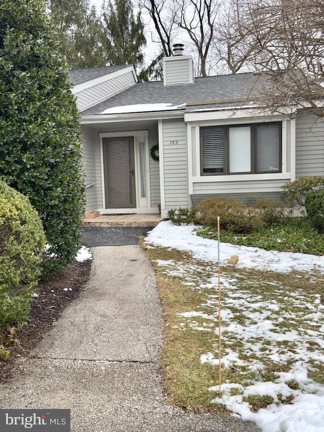 view of snow covered property entrance