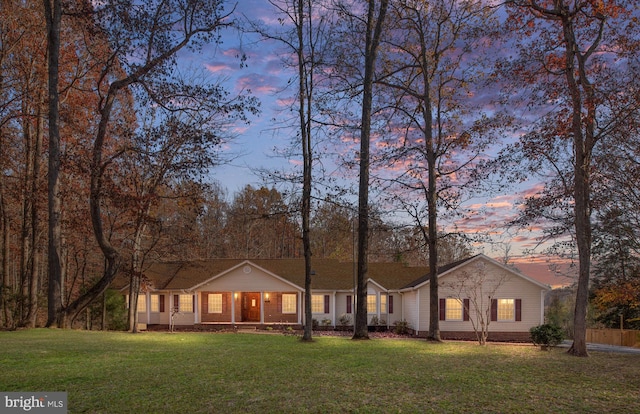 ranch-style home featuring a yard