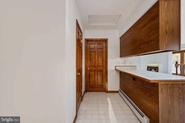 kitchen with kitchen peninsula and a baseboard radiator