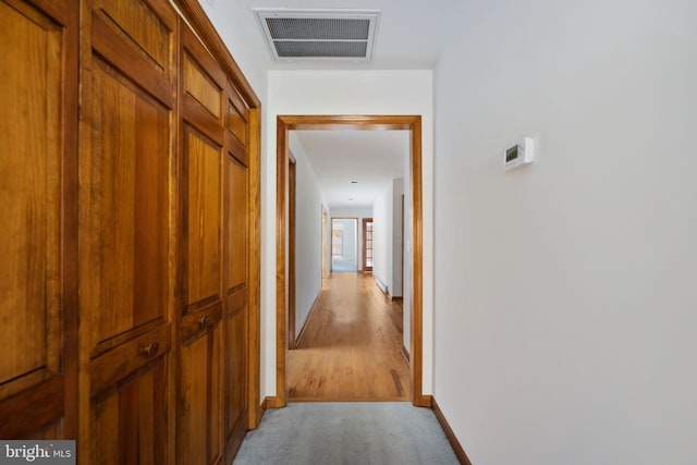 hallway with light colored carpet