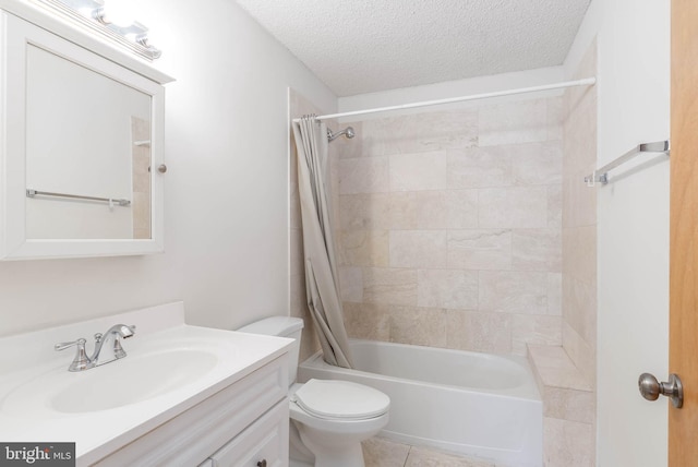 full bathroom featuring toilet, shower / bath combo, tile patterned flooring, a textured ceiling, and vanity