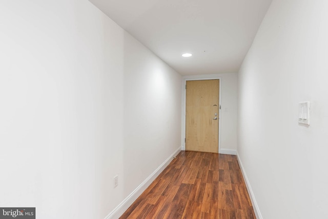 hallway with dark wood-type flooring