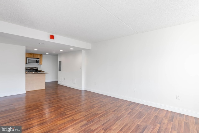 unfurnished living room with dark hardwood / wood-style floors, a textured ceiling, and electric panel