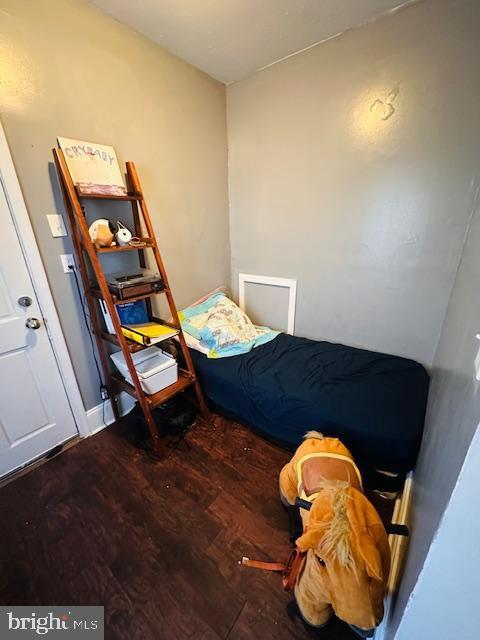 bedroom with dark hardwood / wood-style flooring