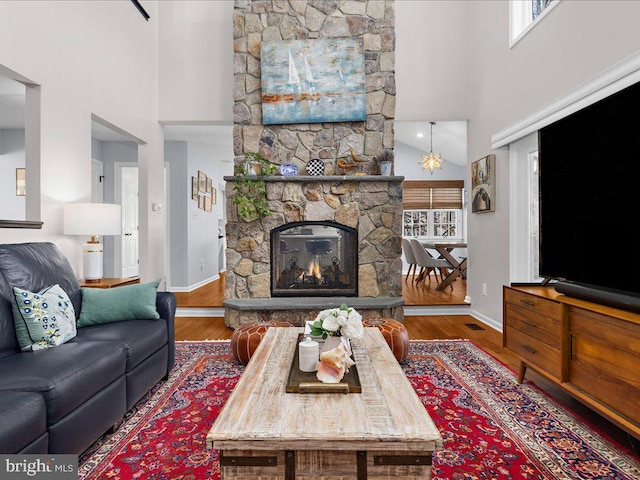 living room featuring a healthy amount of sunlight, hardwood / wood-style floors, and a high ceiling