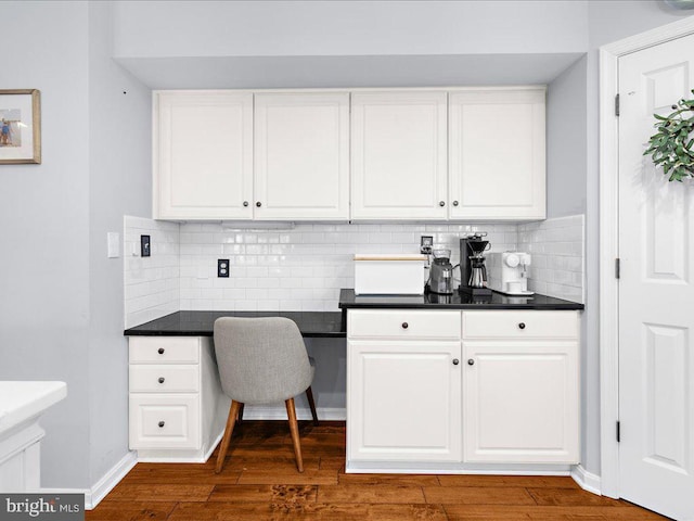 office area with built in desk and dark hardwood / wood-style floors