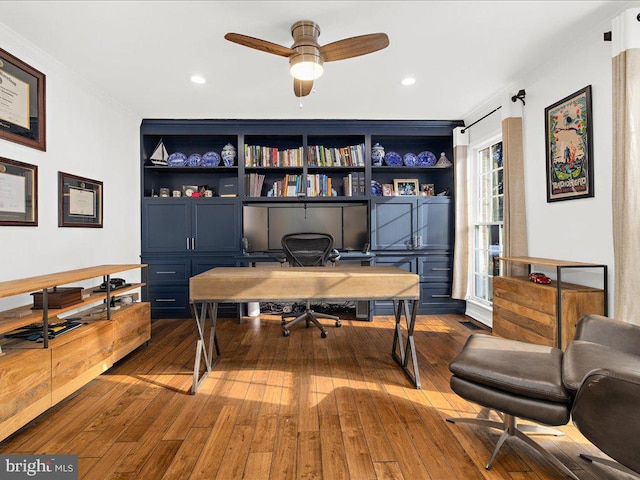 office space with ceiling fan, built in features, and dark hardwood / wood-style flooring