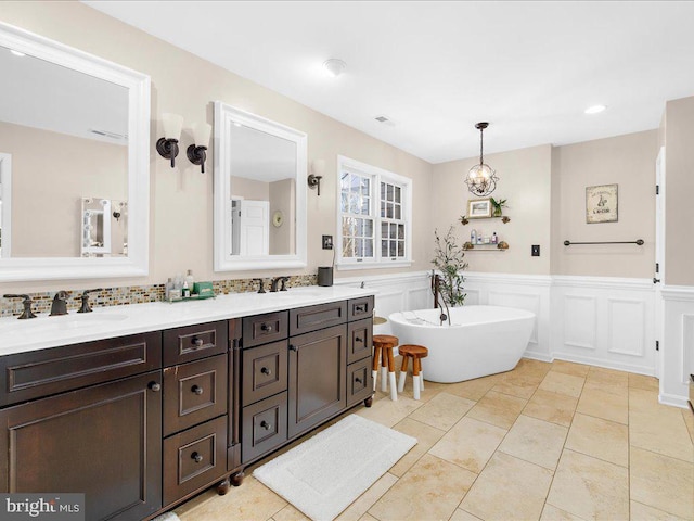 bathroom with vanity, tile patterned flooring, and a washtub