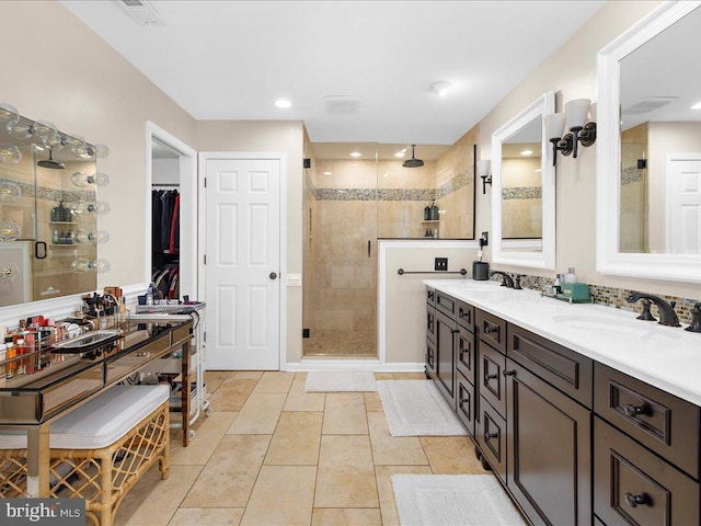 bathroom with a shower with door and vanity