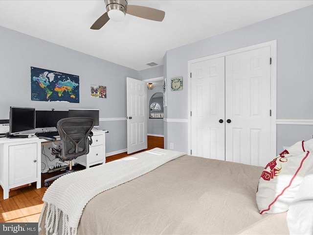 bedroom featuring a closet, ceiling fan, and light hardwood / wood-style flooring