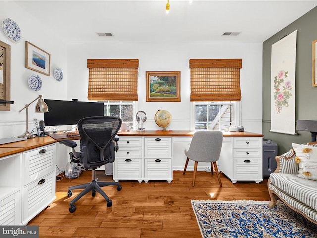 office area with hardwood / wood-style flooring and built in desk