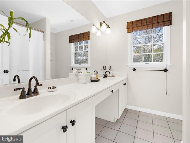 bathroom featuring tile patterned floors, vanity, and a wealth of natural light