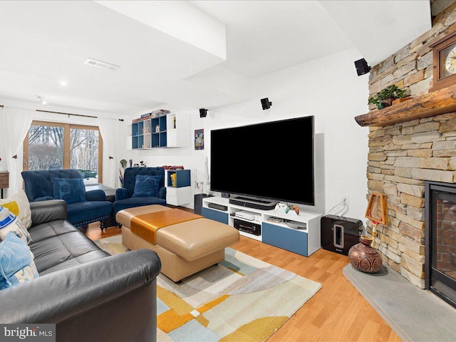 living room with a fireplace and light hardwood / wood-style floors